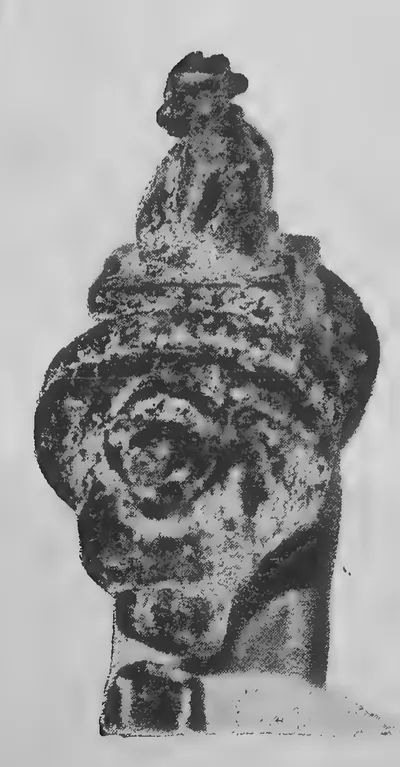 Close photograph of the bronze seal on the ring of the plates: a rounded knob with coiled mouldings, crowned by a small recumbent bull.