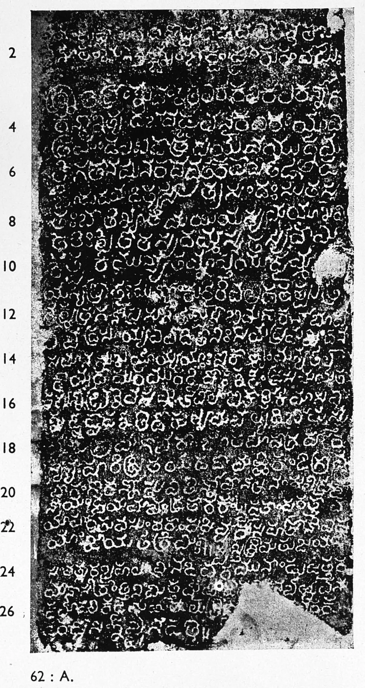Ink impression of an inscribed stone pillar face, small white Telugu letters on black, twenty-six numbered lines; the lower right corner of the stone is broken away.