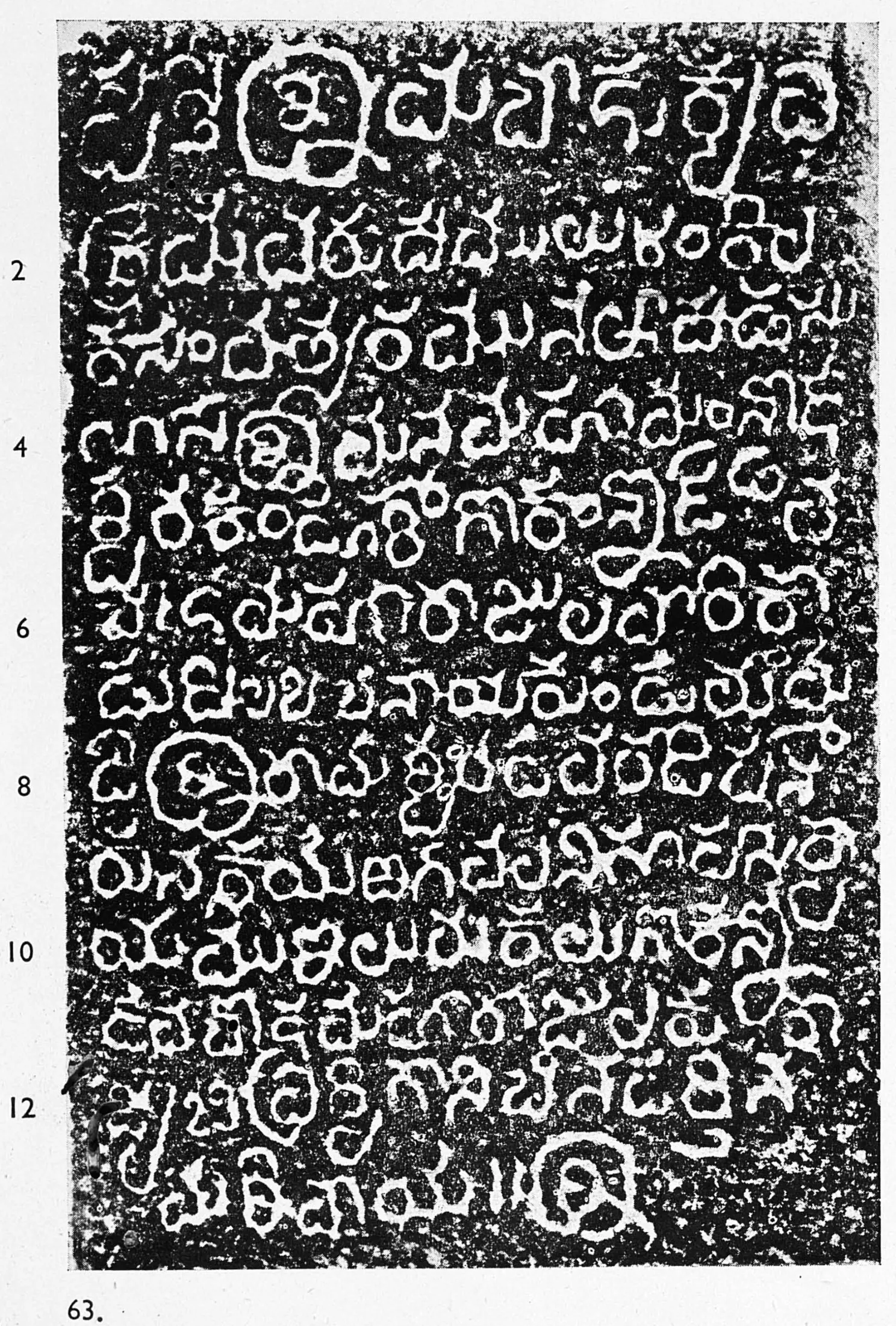 Ink impression of an inscribed stone, bold white Telugu letters on black, thirteen lines numbered 2 to 12, opening with a large ornamental sri.