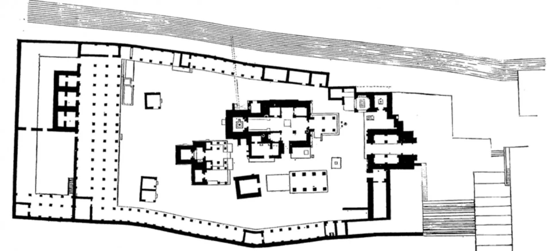Ground plan of the Rajarajesvara temple complex: an irregular walled enclosure lined with pillared colonnades, the main shrine and smaller shrines in the middle, and steps at one side.
