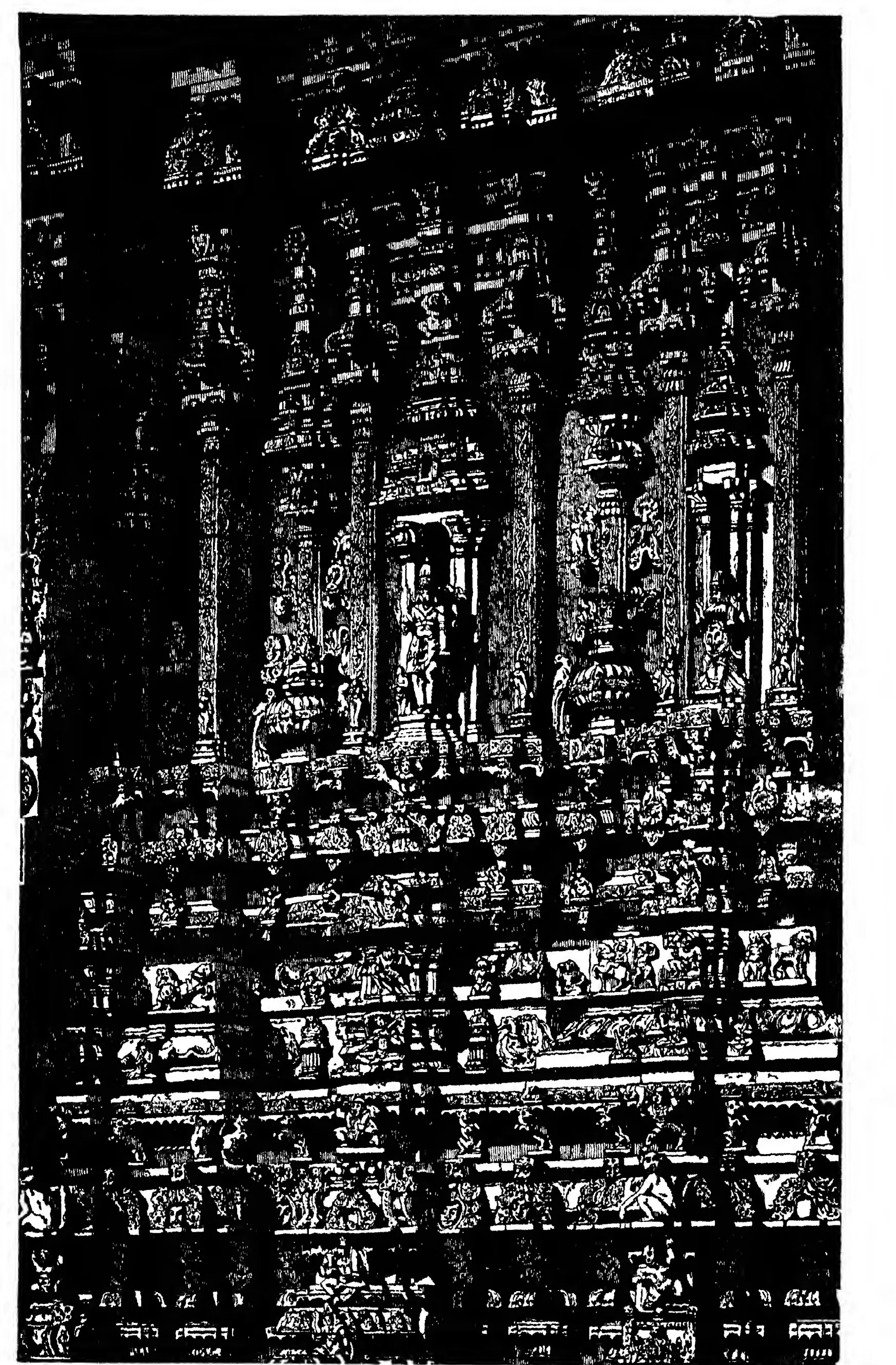 Dense black-and-white woodcut of carved pilasters, niches and friezes on the stone lower storey of a gopuram at Tadpatri.