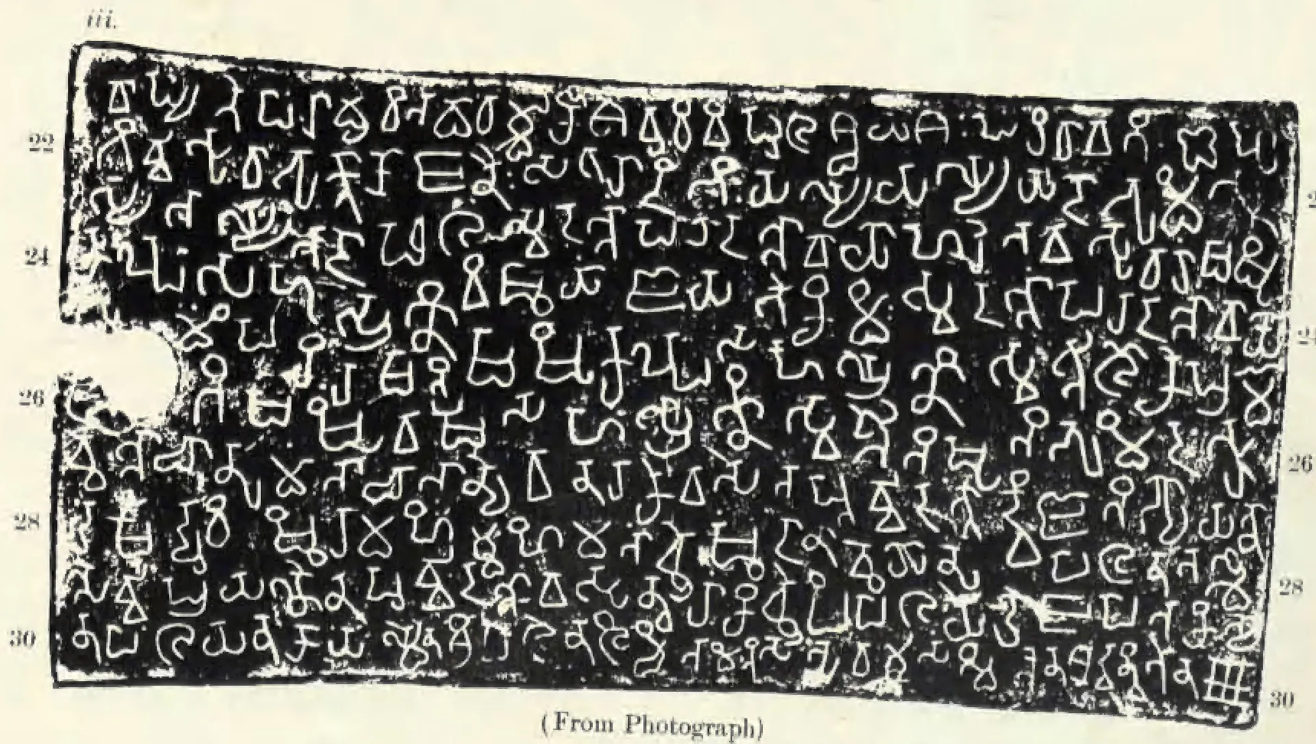 Photograph of one copper-plate side with a notch for the ring at the left edge, nine lines of white southern Brahmi letters on black, labelled iii, with line numbers 22 to 30; the caption (From Photograph) below.